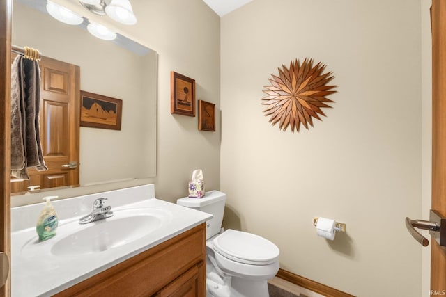 bathroom featuring vanity and toilet