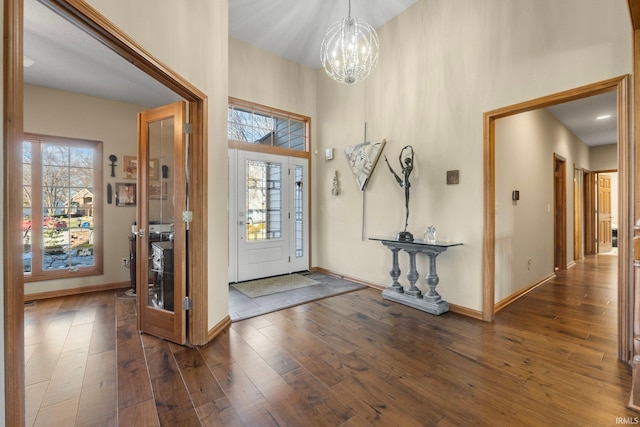 entrance foyer featuring a notable chandelier, dark hardwood / wood-style floors, and a high ceiling