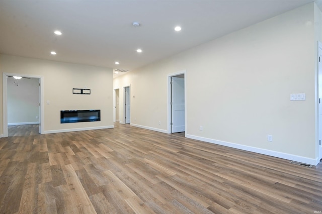 unfurnished living room featuring hardwood / wood-style floors