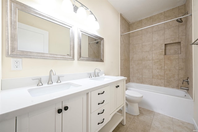 full bathroom with tiled shower / bath combo, vanity, tile patterned flooring, and toilet