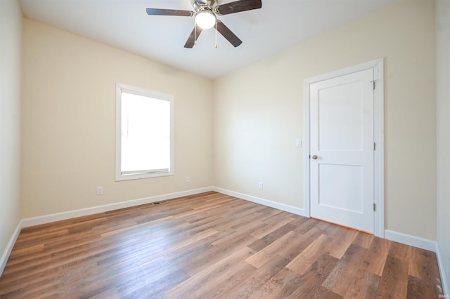 spare room featuring hardwood / wood-style flooring and ceiling fan