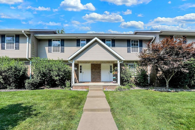 view of property with covered porch and a front lawn