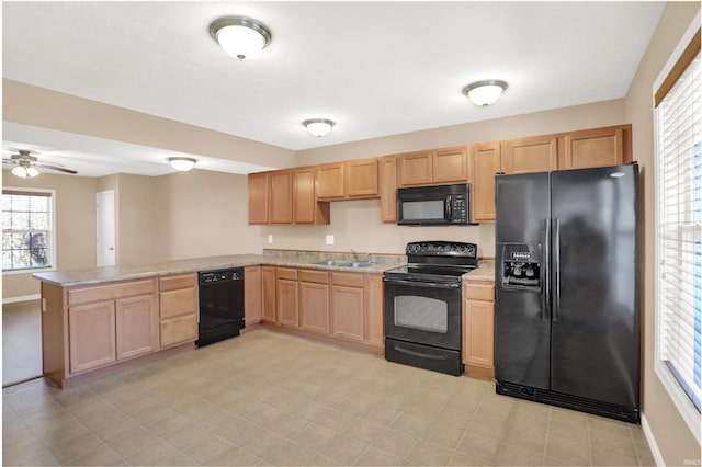 kitchen with light brown cabinetry, sink, kitchen peninsula, ceiling fan, and black appliances