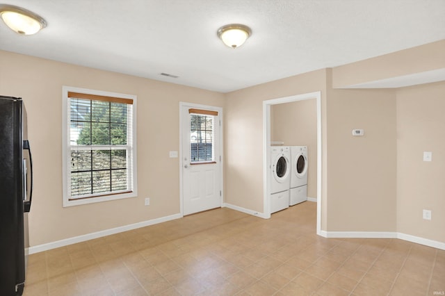 washroom with washing machine and clothes dryer