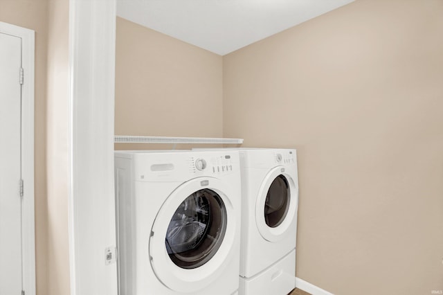 washroom with washing machine and clothes dryer