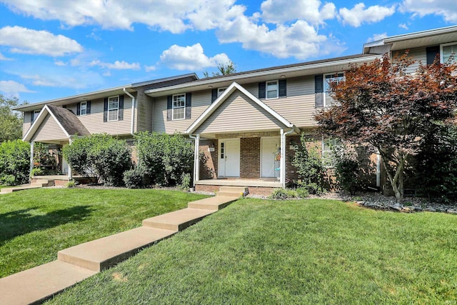 townhome / multi-family property featuring covered porch and a front lawn