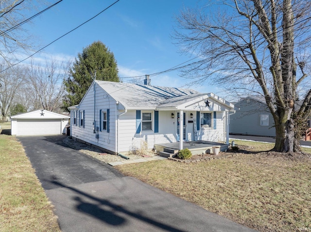 bungalow-style house with an outbuilding, a garage, covered porch, and a front lawn