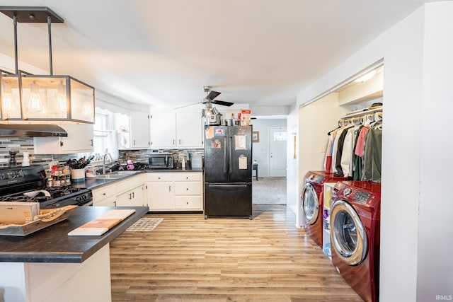 kitchen featuring black appliances, sink, white cabinets, independent washer and dryer, and kitchen peninsula