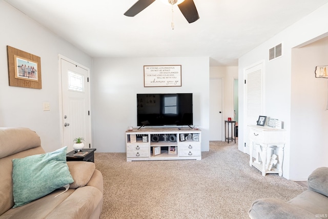 carpeted living room featuring ceiling fan