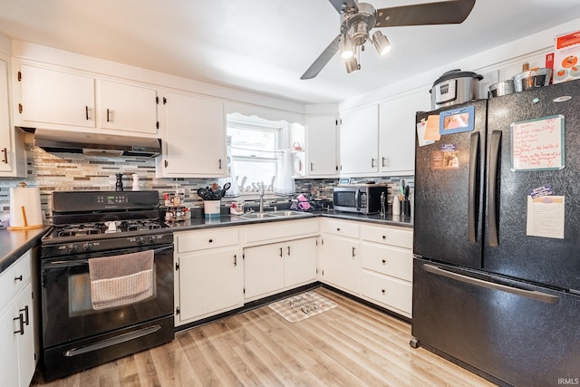 kitchen featuring white cabinetry, tasteful backsplash, and black appliances