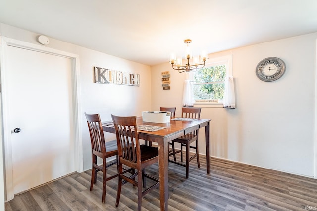 dining room featuring dark wood-type flooring and a chandelier