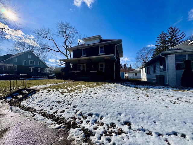 view of snow covered rear of property