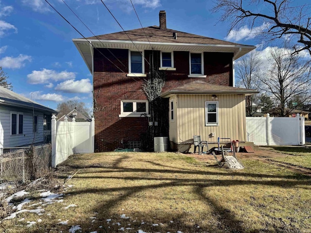 rear view of property featuring central AC unit and a yard