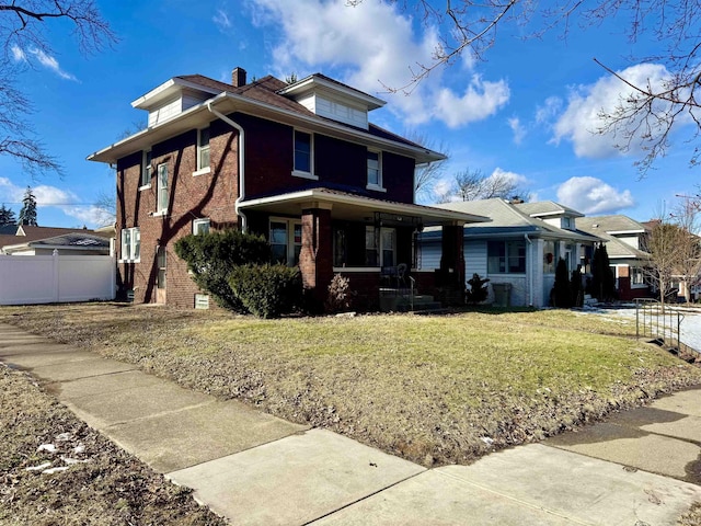 front of property with a front yard and a porch