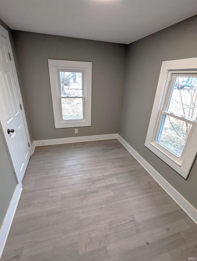 spare room with a healthy amount of sunlight and light wood-type flooring