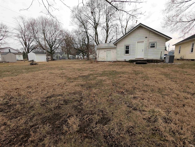 view of yard featuring a shed and central AC