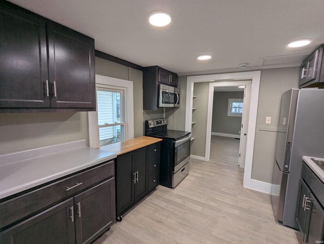 kitchen with plenty of natural light, stainless steel appliances, and light wood-type flooring