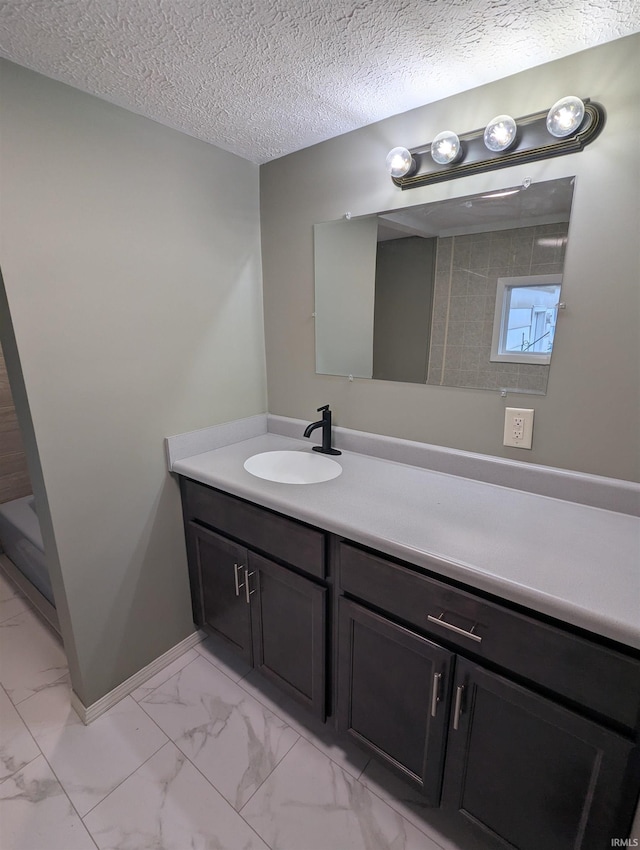 bathroom featuring vanity and a textured ceiling