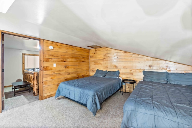 carpeted bedroom featuring vaulted ceiling and wood walls