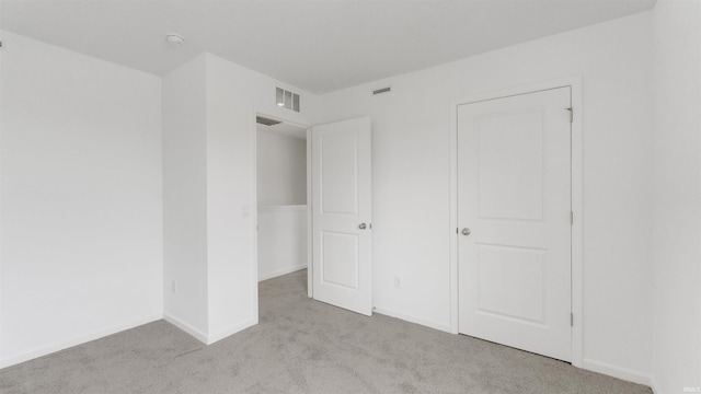 unfurnished bedroom with carpet flooring and visible vents