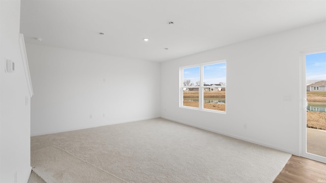 unfurnished room featuring baseboards and carpet floors