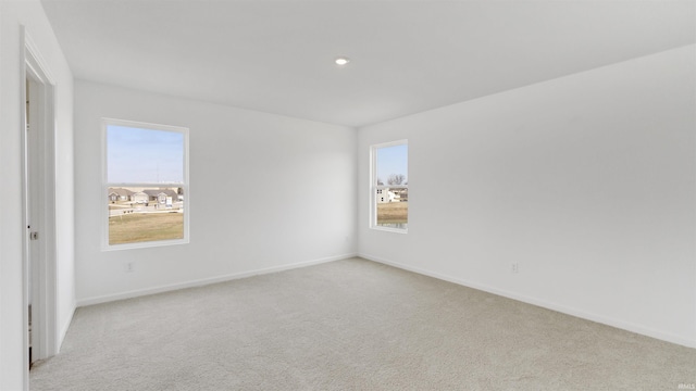 unfurnished room with carpet floors, baseboards, and recessed lighting