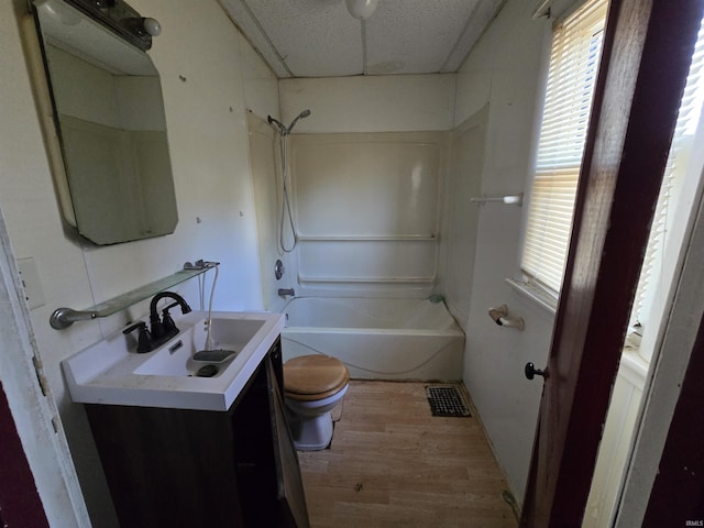 full bathroom with vanity, hardwood / wood-style flooring, plenty of natural light, and toilet