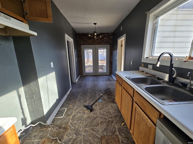 kitchen with dishwasher, sink, and decorative light fixtures