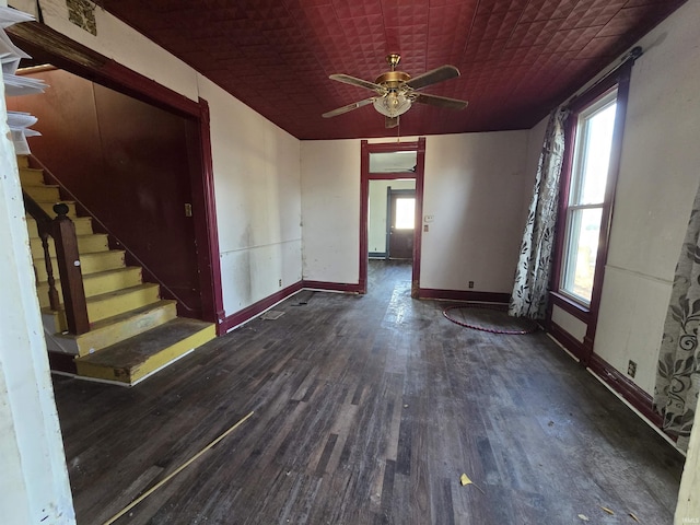 empty room featuring ceiling fan and dark hardwood / wood-style flooring