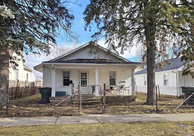 bungalow featuring central air condition unit and a porch