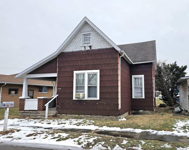 snow covered property featuring covered porch