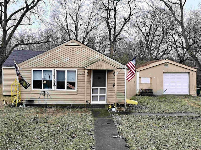 view of front facade featuring a garage and an outdoor structure