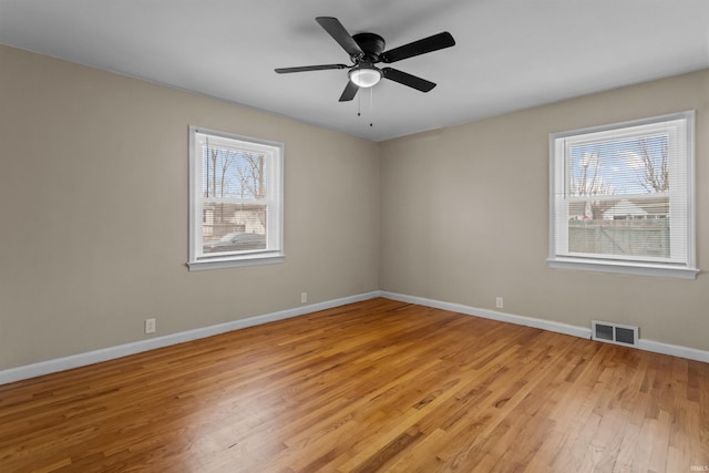 spare room featuring ceiling fan and light hardwood / wood-style floors