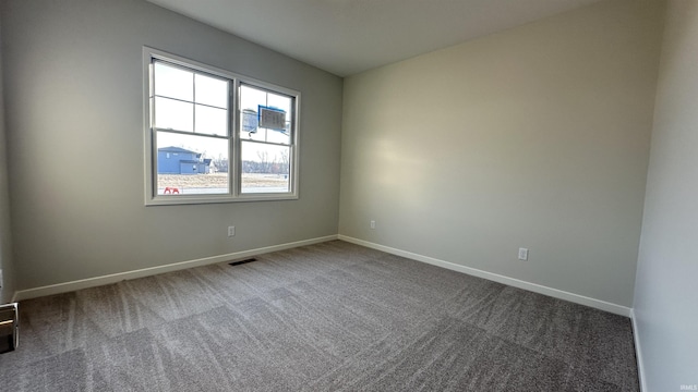 unfurnished room with carpet flooring, baseboards, and visible vents