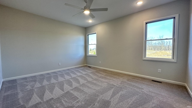 unfurnished room featuring a ceiling fan, visible vents, carpet, baseboards, and recessed lighting