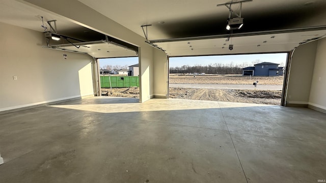 garage with a garage door opener and baseboards