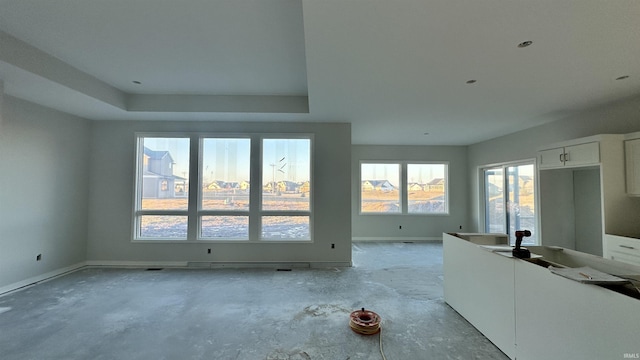 unfurnished living room featuring baseboards