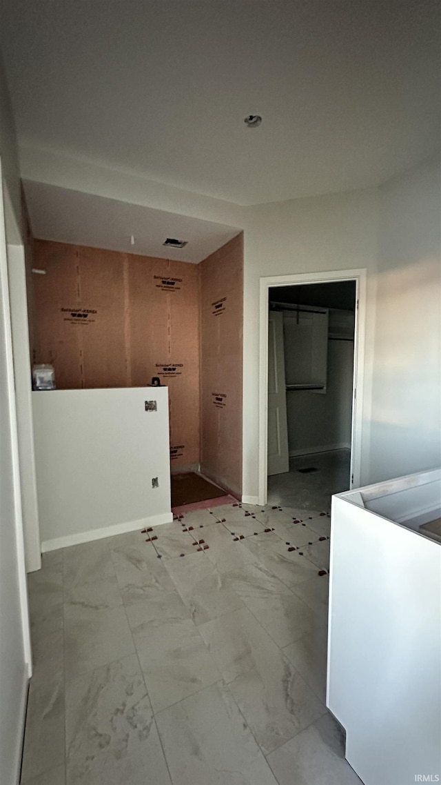 bathroom with marble finish floor and baseboards