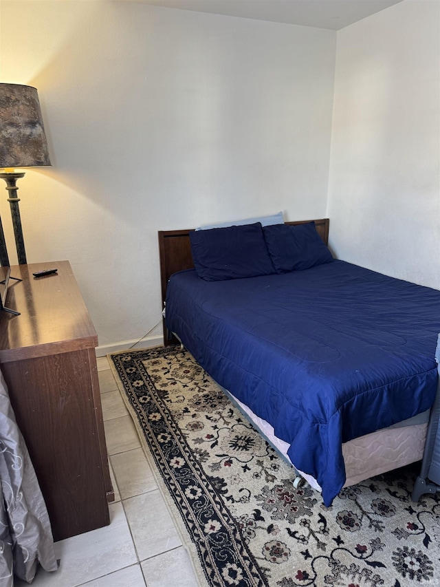 bedroom with light tile patterned floors