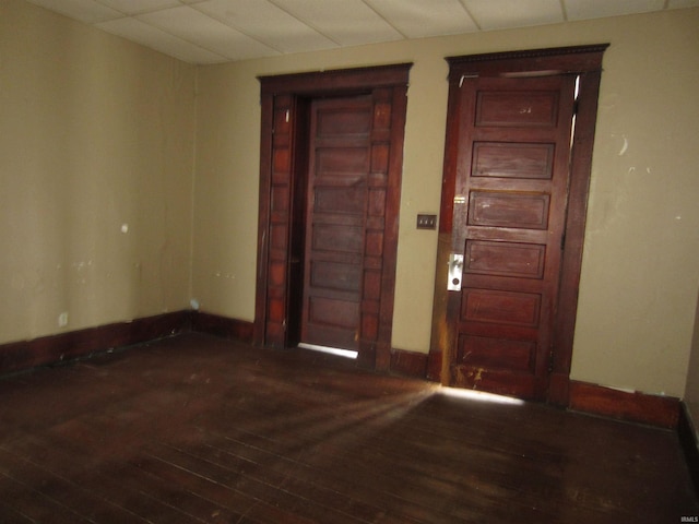 empty room with dark wood-type flooring