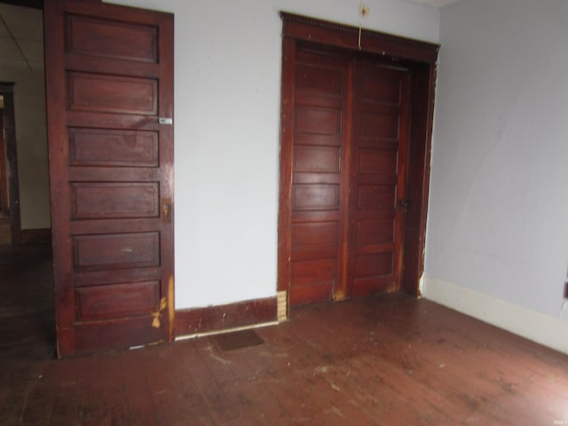 unfurnished bedroom featuring dark hardwood / wood-style flooring