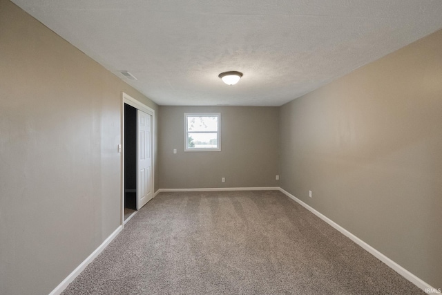 unfurnished bedroom with a closet, carpet flooring, and a textured ceiling