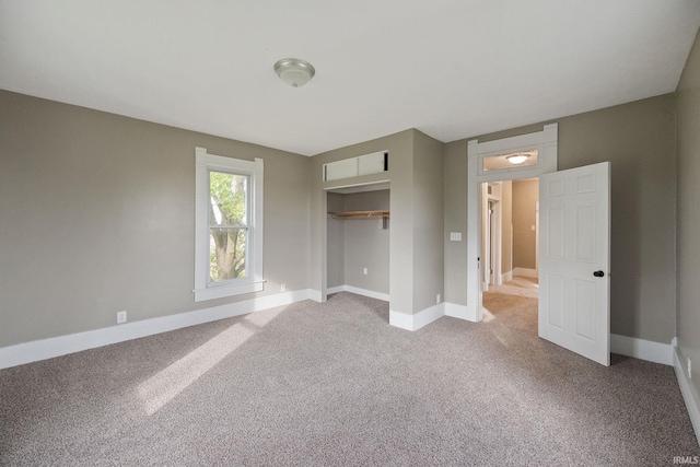 unfurnished bedroom featuring carpet floors and a closet