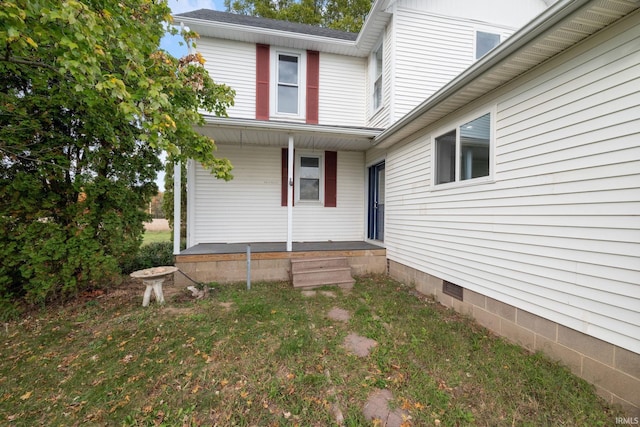 exterior space with covered porch and a lawn