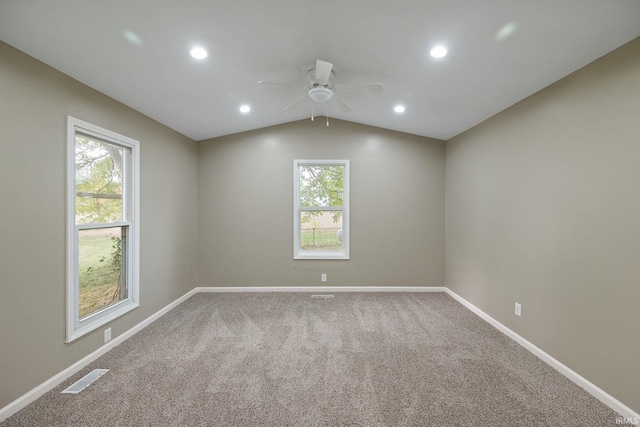 carpeted empty room featuring vaulted ceiling and ceiling fan