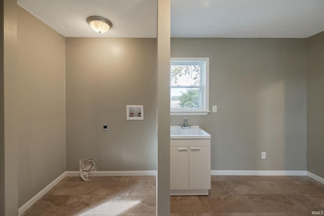 clothes washing area with hookup for an electric dryer, sink, and washer hookup