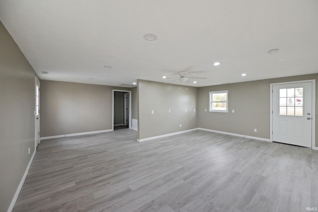 interior space with ceiling fan and light hardwood / wood-style flooring