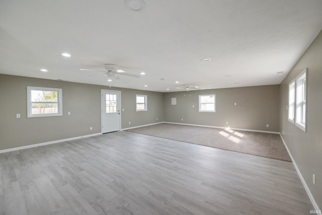 spare room with light hardwood / wood-style floors and ceiling fan