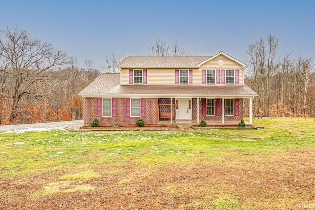 view of front of property featuring a front yard and covered porch