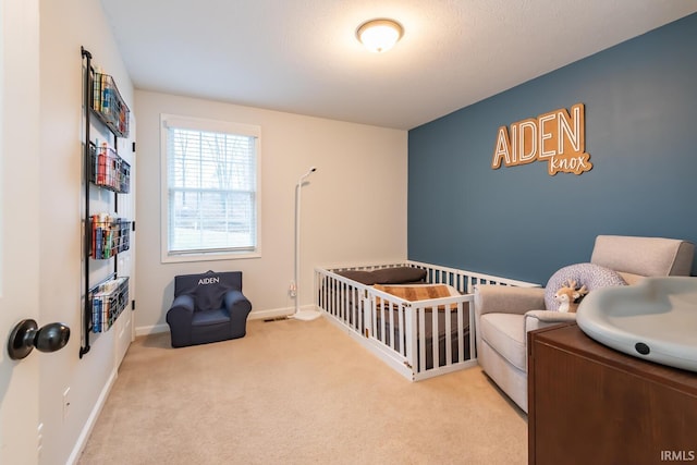 carpeted bedroom featuring a crib